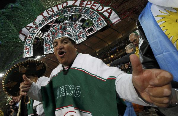 A Mexico fan wearing a strange headwear watches the FIFA World Cup match between Argentine and Mexico on June 27, 2010. [Xinhua/Reuters]