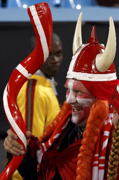 A Denmark fan wearing a strange mask watches the FIFA World Cup match between Denmark and Cameroon on June 19, 2010. [Xinhua/Reuters]