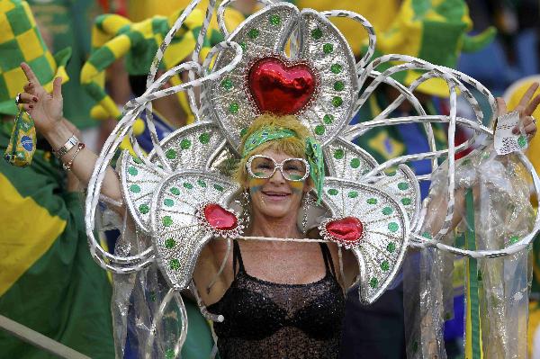 A Brazil fan wearing a strange mask watches the FIFA World Cup match between Brazil and Portugal on June 25, 2010. [Xinhua/Reuters]