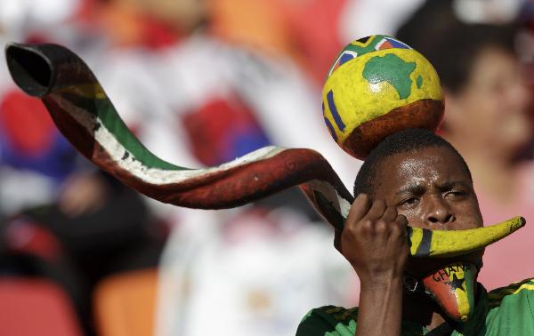 A Brazil fan wearing a strange mask watches the FIFA World Cup match between Brazil and Uruguay on June 26, 2010. [Xinhua/Reuters]