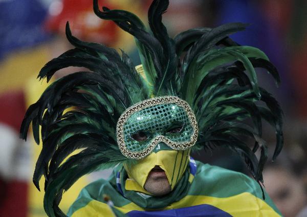 A Brazil fan wearing a strange mask watches the FIFA World Cup match between Brazil and Chile on June 28, 2010. [Xinhua/Reuters]