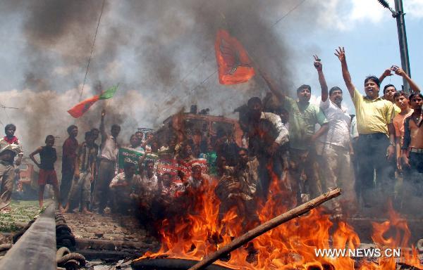 Protestors burn tyres in Bihar state of India, on July 5, 2010. Parts of India Monday got paralyzed by a daylong nationwide strike called out by opposition political parties against the recent hike of fuel prices and the spiraling prices of essential commodities.[Stringer/Xinhua]