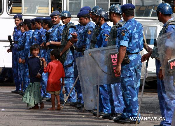 Policemen guard outside Andheri Railway Station in Mumbai, India, on July 5, 2010. Parts of India Monday got paralyzed by a daylong nationwide strike called out by opposition political parties against the recent hike of fuel prices and the spiraling prices of essential commodities. [Prakash Deshmukhr/Xinhua]