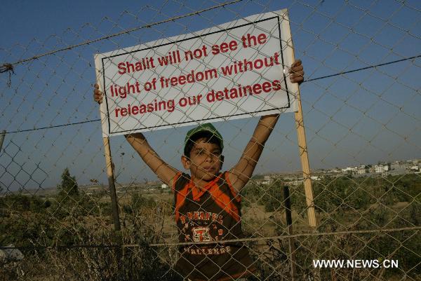 A Palestinian boy takes part in a rally calling for the release of Palestinian prisoners from Israeli jails near Erez crossing between Israel and northern Gaza Strip, July 5, 2010. [Xinhua]