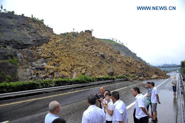 A highway is blocked after a landslide in Chongqing Municipality on July 5, 2010. No vehicle or people were buried in the landslide. 