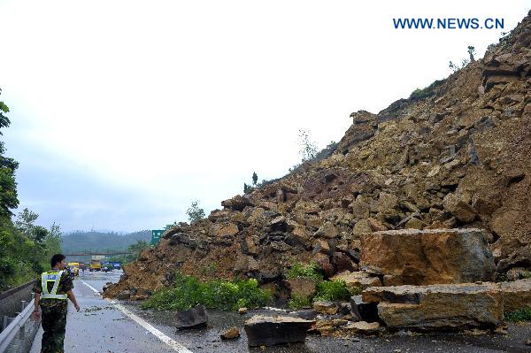 A highway is blocked after a landslide in Chongqing Municipality on July 5, 2010. No vehicle or people were buried in the landslide. 