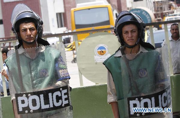 Policemen stand guard at the shooting site, in Hawamdia in October 6 City, 20 km south to Giza, Egypt, 6 July 2010.[Nasser Nouri/Xinhua]