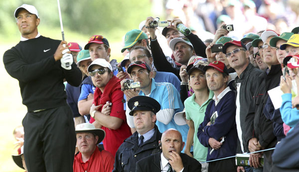 Spectators look on as Tiger Woods plays out of the ruff during the JP McManus Invitational Pro-Am at Adare Manor Hotel and Golf Resort in Limerick July 5, 2010. Tiger Woods slumped to a seven-over-par 79 in the first round of the JP McManus Invitational Pro-Am on Monday. 