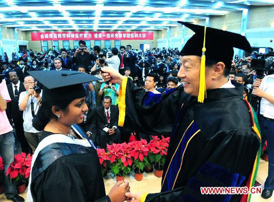 Hao Xishan (R), president of Tianjin Medical University, awards degree to a foreign student during a graduation at Tianjin Medical University in in north China's Tianjin Municipality, July 6, 2010. More than 340 foreign students graduated from Tianjin Medical University Tuesday.