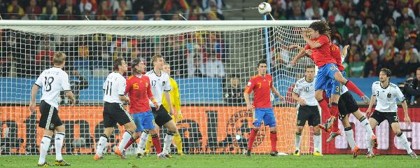 Spain's Carles Puyol (top R) scores a goal during the 2010 World Cup semi-final match against Germany in Durban, South Africa, July 7, 2010. Spain won 1-0.