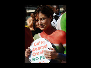 Protestors painted in the colours of flags of various countries hold signs and chant slogans during a demonstration against the fur industry in Johannesburg July 8, 2010. [163.com]