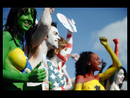 Protestors painted in the colours of flags of various countries hold signs and chant slogans during a demonstration against the fur industry in Johannesburg July 8, 2010. [163.com]