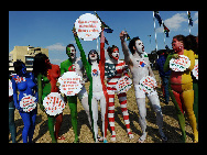 Protestors painted in the colours of flags of various countries hold signs and chant slogans during a demonstration against the fur industry in Johannesburg July 8, 2010. [163.com]