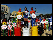 Protestors painted in the colours of flags of various countries hold signs and chant slogans during a demonstration against the fur industry in Johannesburg July 8, 2010. [163.com]