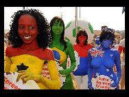 Protestors painted in the colours of flags of various countries hold signs and chant slogans during a demonstration against the fur industry in Johannesburg July 8, 2010. [163.com]