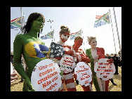 Protestors painted in the colours of flags of various countries hold signs and chant slogans during a demonstration against the fur industry in Johannesburg July 8, 2010. [163.com]