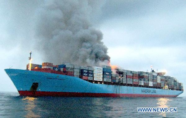 Smoke rises from Charlotte Maersk, a Dutch cargo ship which caught fire en route from Malaysia&apos;s Port Klang to Oman on July 7, 2010. No casualties or injuries are reported thus far. [Xinhua]