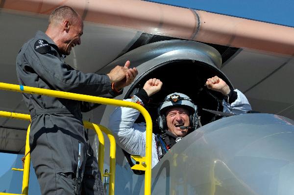 Solar Impulse&apos;s team chief Bertrand Piccard, left and Solar Impulse&apos;s Chief Executive Officer and pilot Andre Borschberg celebrate after successfully landing the solar-powered HB-SIA prototype airplane after its first successful night flight attempt at Payerne airport on Thursday, July 8, 2010.[Xinhua/Reuters]