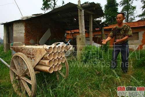 Yang Deyou displays his improvised rocket in a wooden booth built above the roof of his house in suburban Wuhan, Hubei province