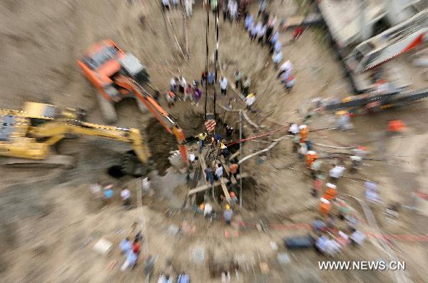 Rescuers work at a construction site in Nantong, east China's Jiangsu Province, July 8, 2010. A seven-year-old boy fell into a 15-meter-deep and 30-centimeter-in-diameter pile hole at the site around 6:00 p.m. local time Wednesday, and was successfully extricated after 20 hours' effort.