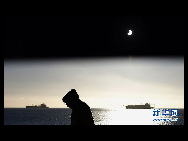 The moon passes between the sun and the earth during a solar eclipse in Valparaiso City, 75 miles (121 km) northwest of Santiago, July 11, 2010.[Xinhua/Reuters] 