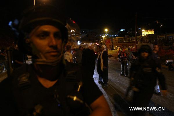 Israeli police officers stand guard during clashes between residents and Israeli police, in the village of Majdal Shams, July 11, 2010. Syrian citizens in the Israeli-occupied Golan Heights captured three Israeli soldiers during a security mission by an Israeli force in the territory. The Israeli soldiers were in a mission to storm houses of two Syrian families in Majdal Shams village when the local citizens seized them inside one of the two houses. [Xinhua]