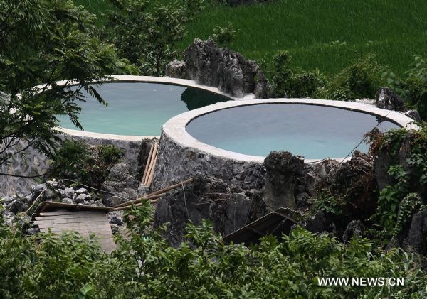 Two newly-built water tanks full of rain water are seen in Jishan Village of Fengshan County, southwest China&apos;s Guangxi Zhuang Autonomous Region, July 12, 2010. The county planned to build more than 1,800 water tanks during the rainy season to fight against the dry season. (Xinhua/Zhou Enge)(wyo) 