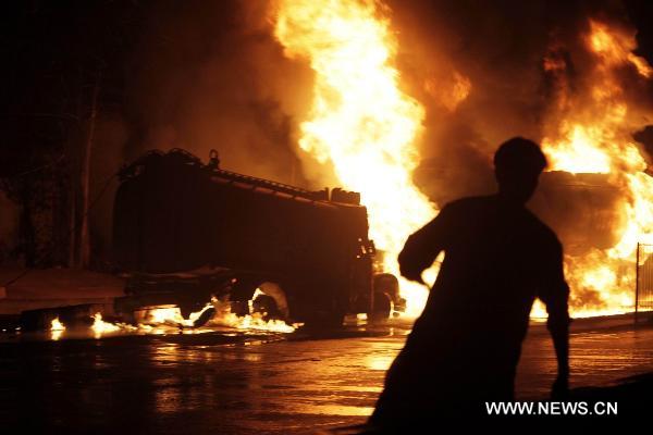 Fire rages after NATO oil tanks were attacked by unknown militants in northwest Pakistani city of Peshawar on July 13, 2010. At least three NATO oil tankers were burned and seven other vehicles were also set fire on the outskirts of Peshawar during the attack. [Umar Qayyum]