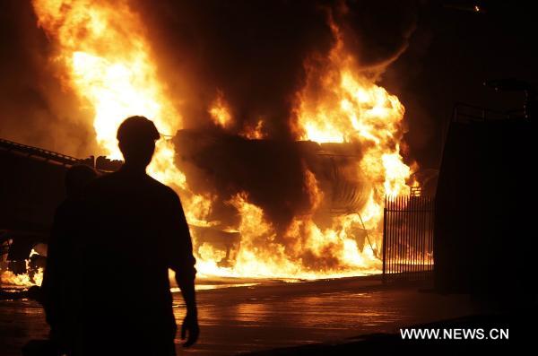 Fire rages after NATO oil tanks were attacked by unknown militants in northwest Pakistani city of Peshawar on July 13, 2010. At least three NATO oil tankers were burned and seven other vehicles were also set fire on the outskirts of Peshawar during the attack. [Umar Qayyum]