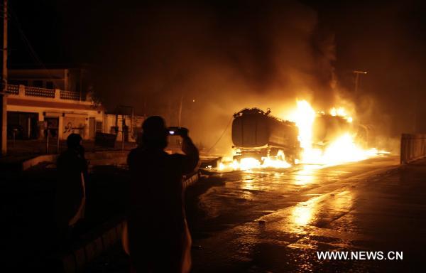 Fire rages after NATO oil tanks were attacked by unknown militants in northwest Pakistani city of Peshawar on July 13, 2010. At least three NATO oil tankers were burned and seven other vehicles were also set fire on the outskirts of Peshawar during the attack. [Umar Qayyum]