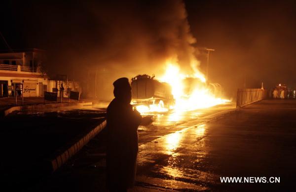 Fire rages after NATO oil tanks were attacked by unknown militants in northwest Pakistani city of Peshawar on July 13, 2010. At least three NATO oil tankers were burned and seven other vehicles were also set fire on the outskirts of Peshawar during the attack. [Umar Qayyum]