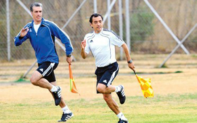 Assistant referees run along the pitch during a FIFA referee training session in Derdepoort, South Africa, on June 21. 