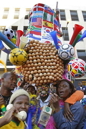 South African supporter Gregory Da Silva, who called himself The Egg Man, holds a 25-kilogram hat as he walks among World Cup supporters in Cape Town on June 17. 