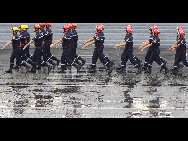 French firefighters march during the France's Bastille Day military parade held in Paris, capital of France, on July 14, 2010. [Xinhua]