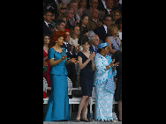 David SilpaCameroon First Lady Chantal Biya (L), France First Lady Carla Bruni-Sarkozy (C) and Burkina Faso First Lady Chantal Compaore watch the annual military parade at the Place de la Concorde during the Bastille Day celebrations in Paris on July 14, 2010. [Xinhua]