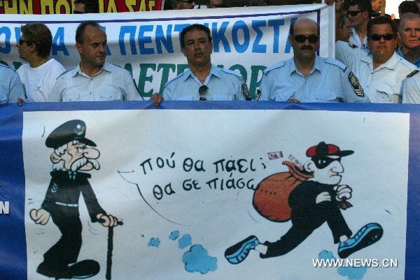 Greek police and firemen demonstrate against austerity measures in front of the Parliament in central Athens on July 14, 2010. [Marios Lolos/Xinhua] 