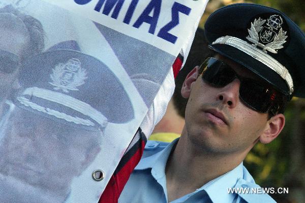 Greek police and firemen demonstrate against austerity measures in front of the Parliament in central Athens on July 14, 2010. [Marios Lolos/Xinhua] 