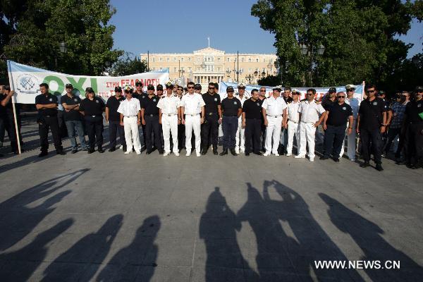 Greek police and firemen demonstrate against austerity measures in front of the Parliament in central Athens on July 14, 2010. [Marios Lolos/Xinhua] 