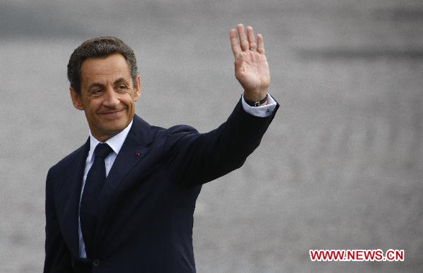 French President Nicolas Sarkozy waves during the France&apos;s Bastille Day military parade held in Paris, capital of France, on July 14, 2010. French President Nicolas Sarkozy and leaders from 13 African countries attended the military parade marking France&apos;s Bastille Day on July 14.[Zhang Yuwei/Xinhua]