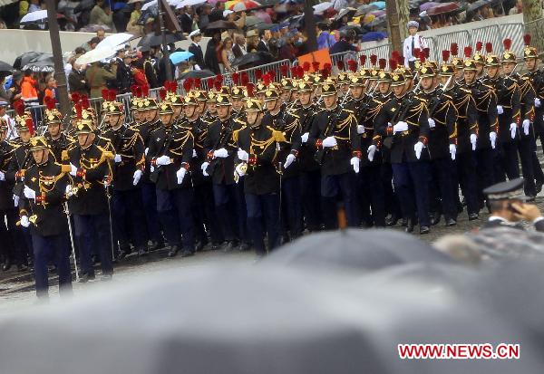 French soldiers march during the France&apos;s Bastille Day military parade held in Paris, capital of France, on July 14, 2010. French President Nicolas Sarkozy and leaders from 13 African countries attended the military parade marking France&apos;s Bastille Day on July 14. [Zhang Yuwei/Xinhua]