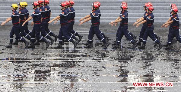 French firefighters march during the France&apos;s Bastille Day military parade held in Paris, capital of France, on July 14, 2010. French President Nicolas Sarkozy and leaders from 13 African countries attended the military parade marking France&apos;s Bastille Day on July 14. [Zhang Yuwei/Xinhua]