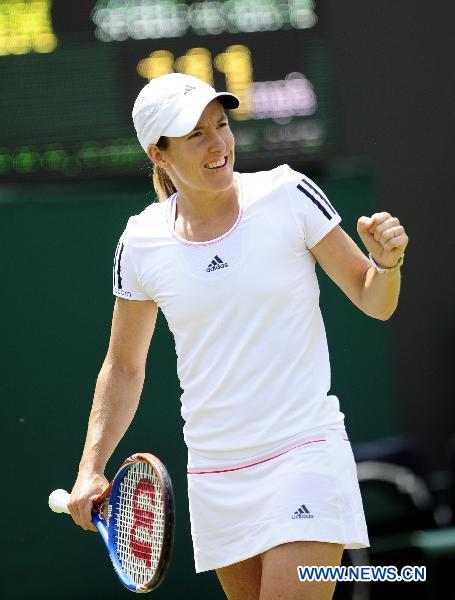 Justine Henin of Belgium celebrates a score during her second round match of women's singles against Kristina Barrois of Germany in the 2010 Wimbledon Championships in London, Britain, June 23, 2010. (Xinhua/Zeng Yi)