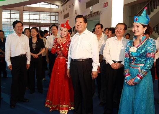 Jia Qinglin (C, front), chairman of the National Committee of the Chinese People's Political Consultative Conference, visits the exhibition of the Inner Mongolia Autonomous Region during the 'West Development' campaign, in Beijing, capital of China, July 14, 2010. [Xinhua]