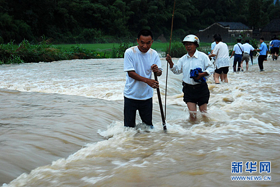 Rescue workers rush to reinforce dykes and embankment of the Meixi reservoir in Jiangxi Province on July 14, 2010.