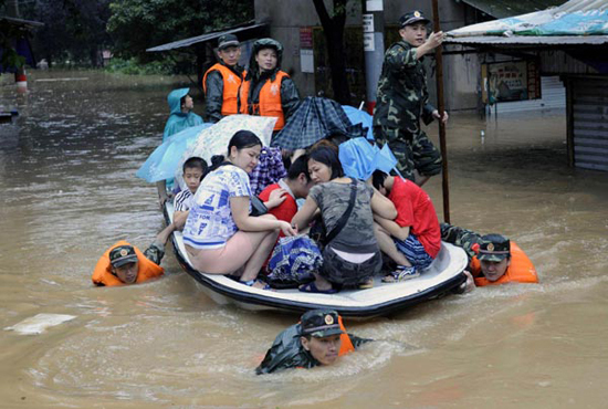 Rescuers relocate flood victims in Anqing, Anhui province, on July 13, 2010. 