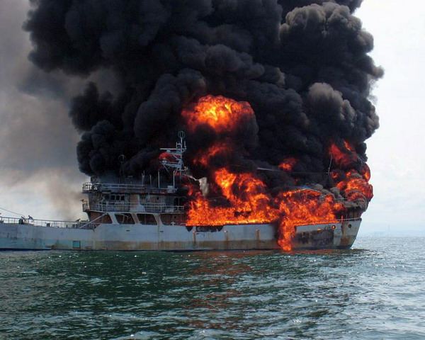 The rear of a Taiwanese fishing boat is seen engulfed in flames when it was passing through the Malacca Straits to reach Singapore, July 15, 2010. The eight fishermen on board, including two Chinese and six Filipinos, have been sent to the hospital. Their injuries were not life threatening. The preliminary cause of the fire seems to be an engine breakdown.[Xinhua]