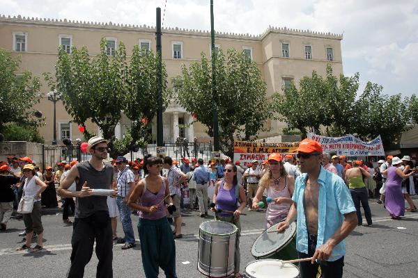 Greek civil servants stage a theatrical performance during a demonstration to protest the austerity measures and the reform of the pension system in Athens, capital of Greece, July 15, 2010. The umbrella labor union of public sector employees in Greece staged a four- hour work stoppage, as the parliament was due to approve the bill which is presented by the the Greek government as a vital step to face a severe economic crisis.[Marios Lolos/Xinhua]