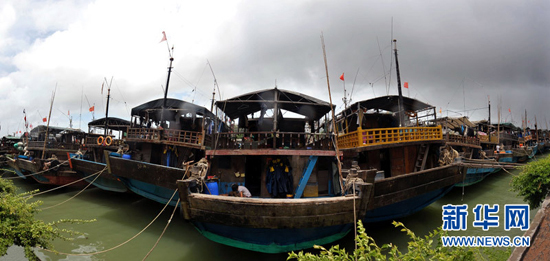 Fishing boats sheltered from typhoon in Haikou port, Hainan Province, on July 16, 2010. China issued an orange alert on Thursday for wave surges, the second highest level warning, forecasting that Typhoon Conson may reach land Friday on the southeast coast of Hainan Province.