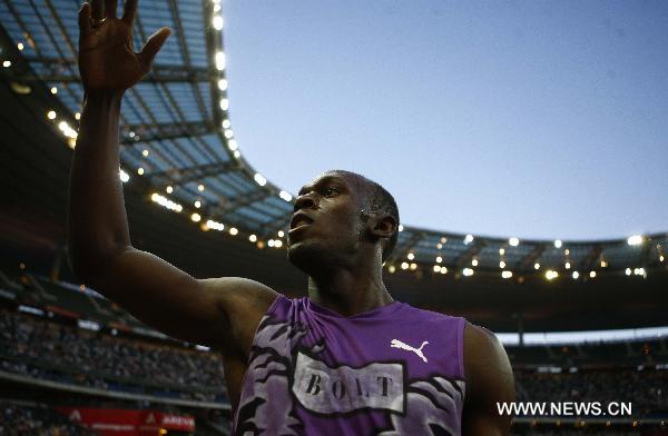 Usain Bolt of Jamaica celebrates after winning the men&apos;s 100m event of the Paris IAAF Diamond League meeting at the Stade de France in Saint-Denis, near Paris, France, July 16, 2010. Bolt claimed the title with a time of 9.84 seconds. [Zhang Yuwei/Xinhua]
