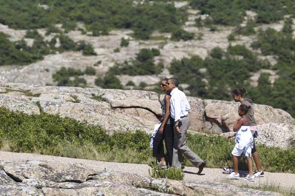 U.S. President Barack Obama (2nd L) and his wife Michelle (L) walk along a trail with their daughters Sasha and Malia (2nd L) on Cadillac Mountain in Bar Harbor, Maine, July 16, 2010. The First Family is on vacation for the weekend. [Xinhua]